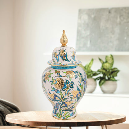 Hand-painted Golden Bloom ceramic jar with blue tulips, green leaves & gold accents. Finished with sculpted golden finial, artisan-made, perfect décor or gift.