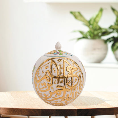 Hand-painted Gold Script globe jar with Arabic calligraphy and turquoise floral motifs. Spherical ceramic design with gold finial, perfect décor or gift.