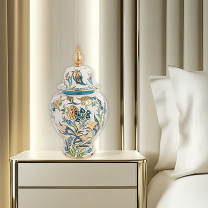 Hand-painted Golden Bloom ceramic jar with blue tulips, green leaves & gold accents. Finished with sculpted golden finial, artisan-made, perfect décor or gift.