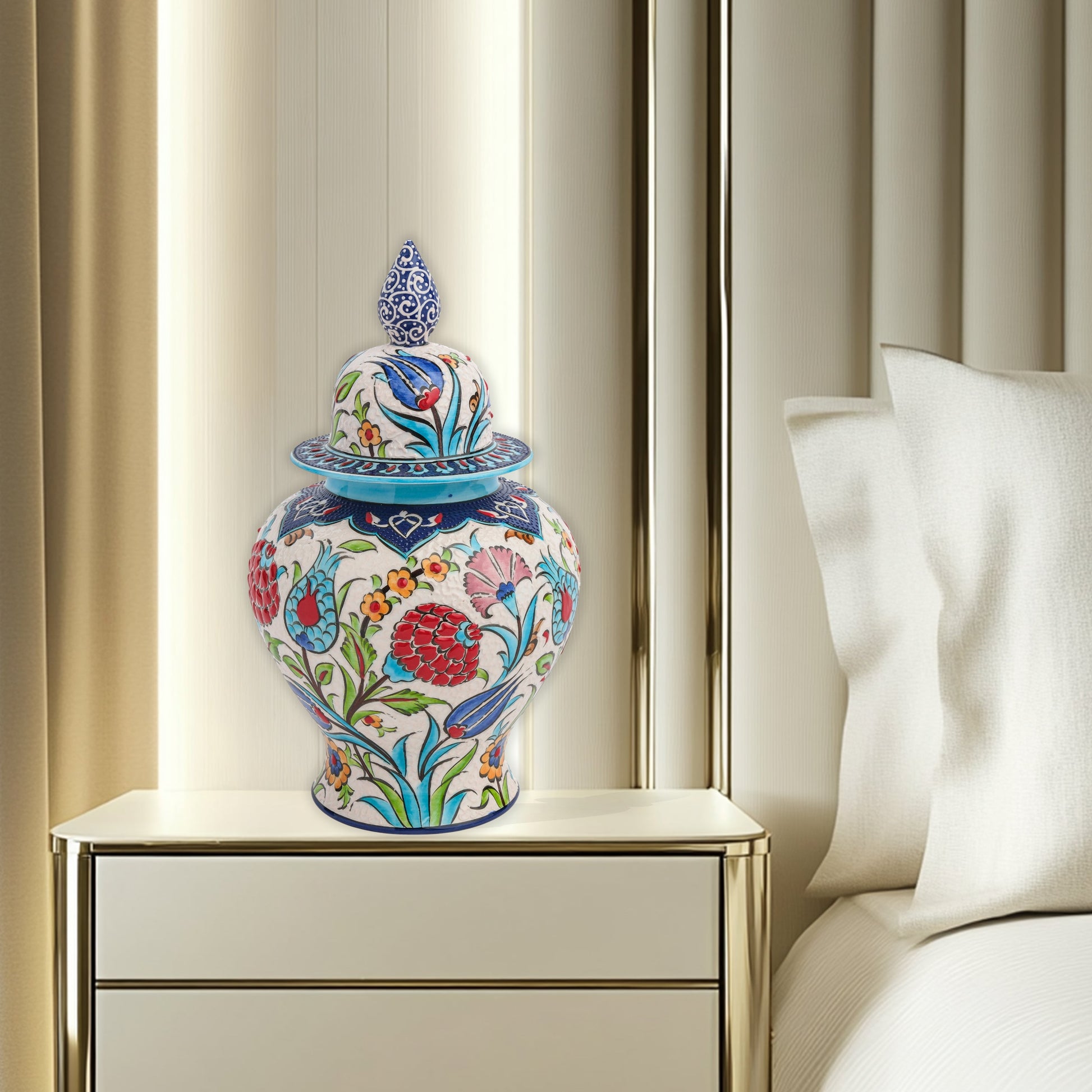 Hand-painted Floral Festival ceramic jar with red carnations, blue tulips & yellow blossoms. Glossy artisan jar with cobalt finial lid, perfect décor or gift.