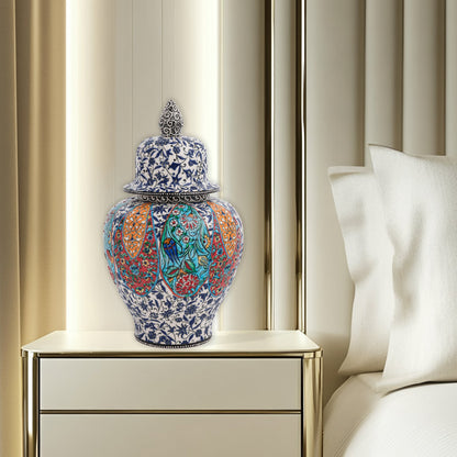 Hand-painted Garden Song ceramic jar with floral and bird motifs in vibrant panels. Lidded artisan jar with ornate finial, perfect décor accent or gift.