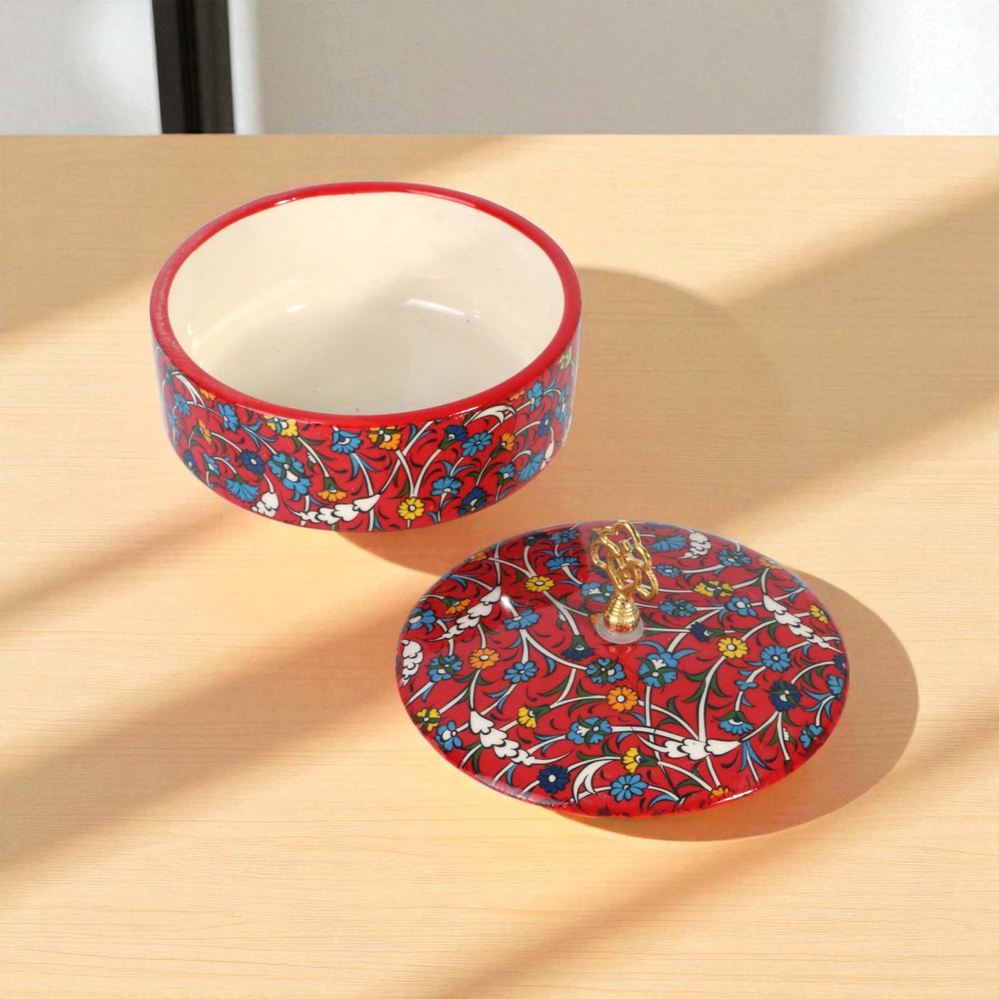 Ceramic sugar bowl with floral design on a beige surface