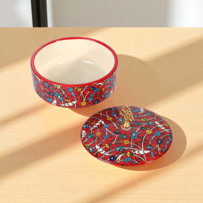 Ceramic sugar bowl with floral design on a beige surface