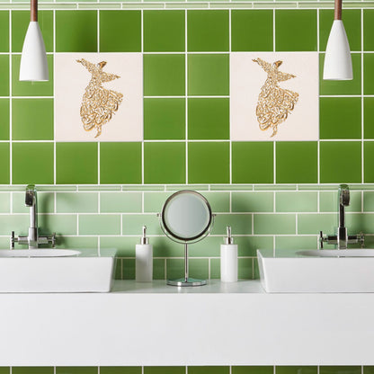 Bathroom with green tiles and decorative ceramic tiles above a sink.