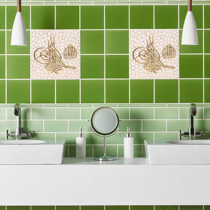Bathroom with green tiles and decorative ceramic tile above a sink.