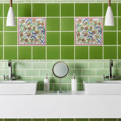 Bathroom with green tiled wall and decorative ceramic tiles above sinks.