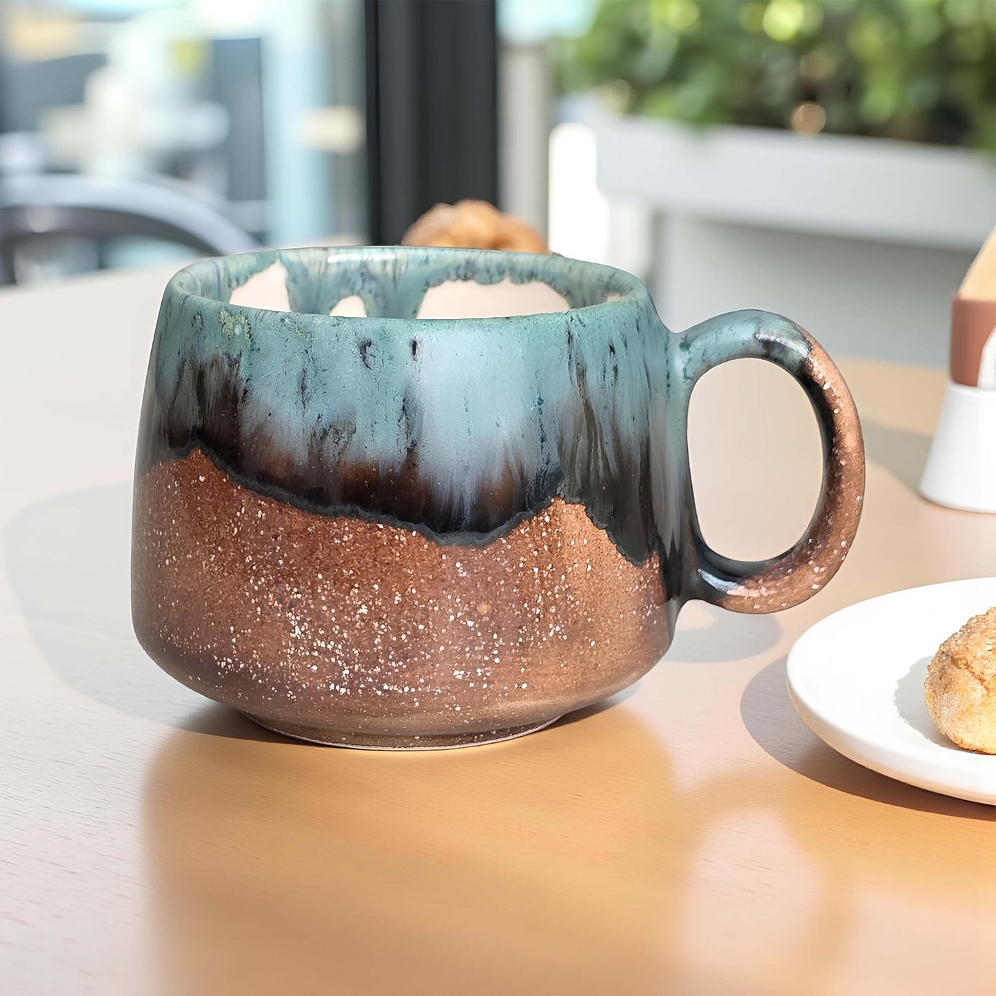 Speckled ceramic mug on a table with a blurred background