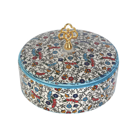 Decorative sugar bowl with floral pattern and gold lid on a white background