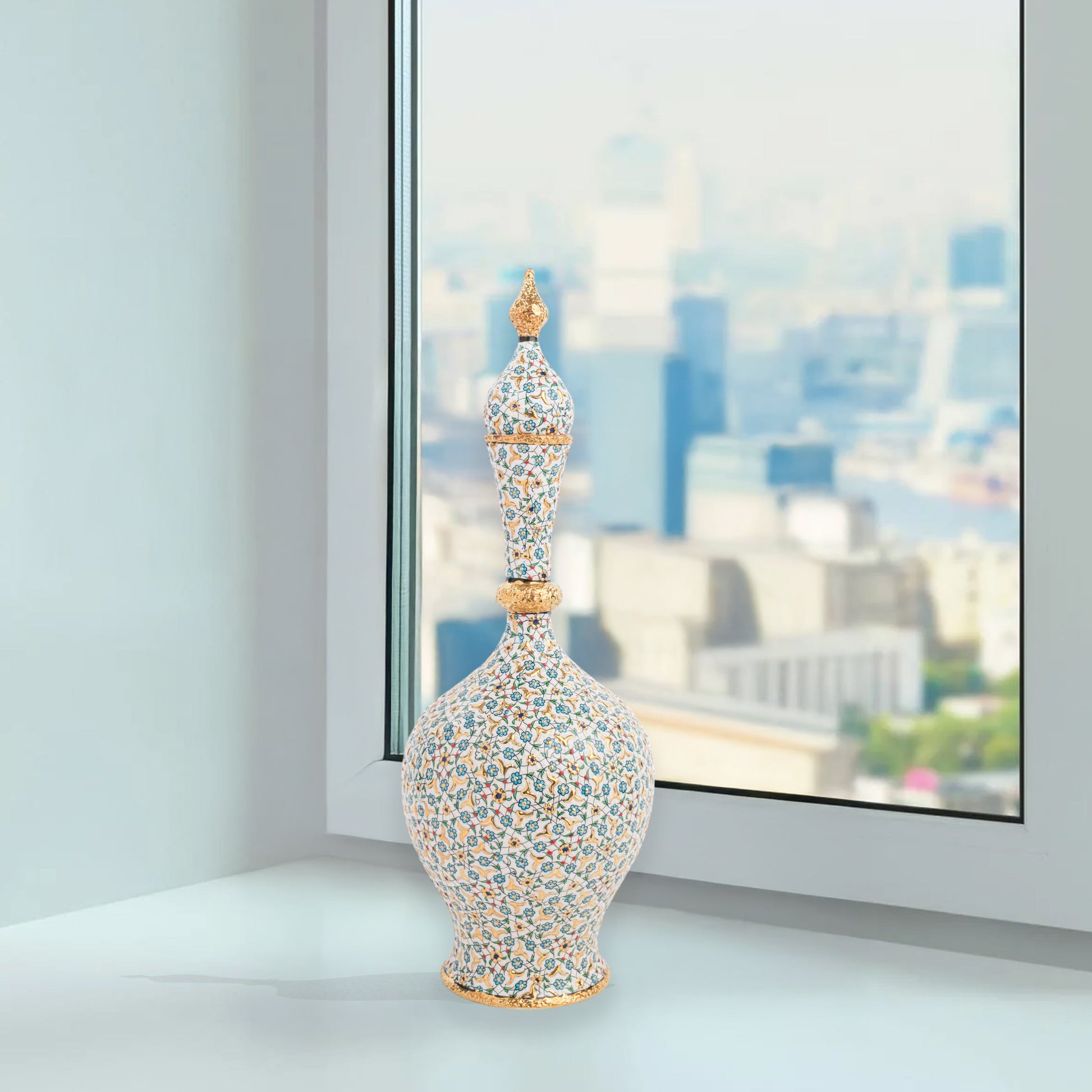 Hand-painted ceramic decorative bottle with turquoise floral motifs and golden details. Minaret-inspired shape with spire lid, perfect for décor or gifting.