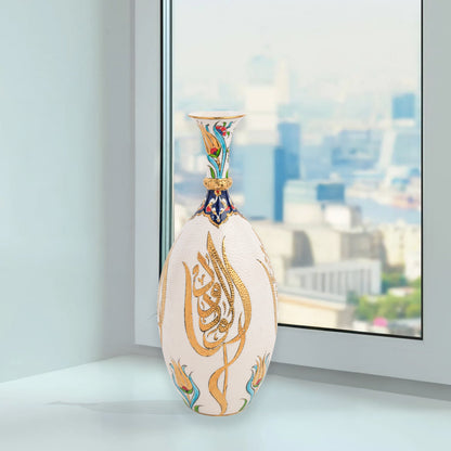 Hand-painted ceramic decorative bottle with golden Arabic calligraphy on ivory, accented with floral motifs. Glossy artisan vase, perfect for décor or gifts.