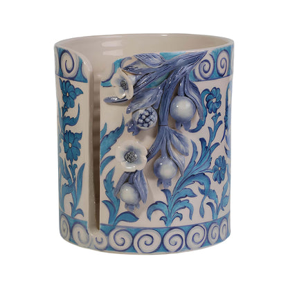 Decorative ceramic paper towel holder with blue floral patterns on a white background