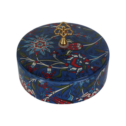 Decorative sugar bowl with floral patterns and a gold lid on a white background