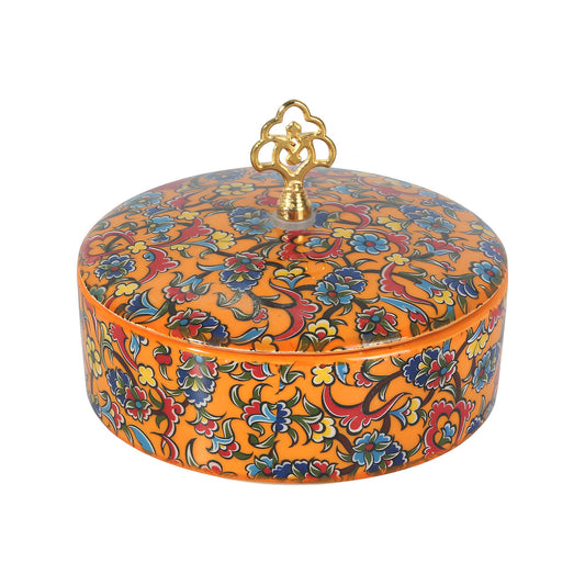 Decorative sugar bowl with colorful floral patterns and a gold lid on a white background