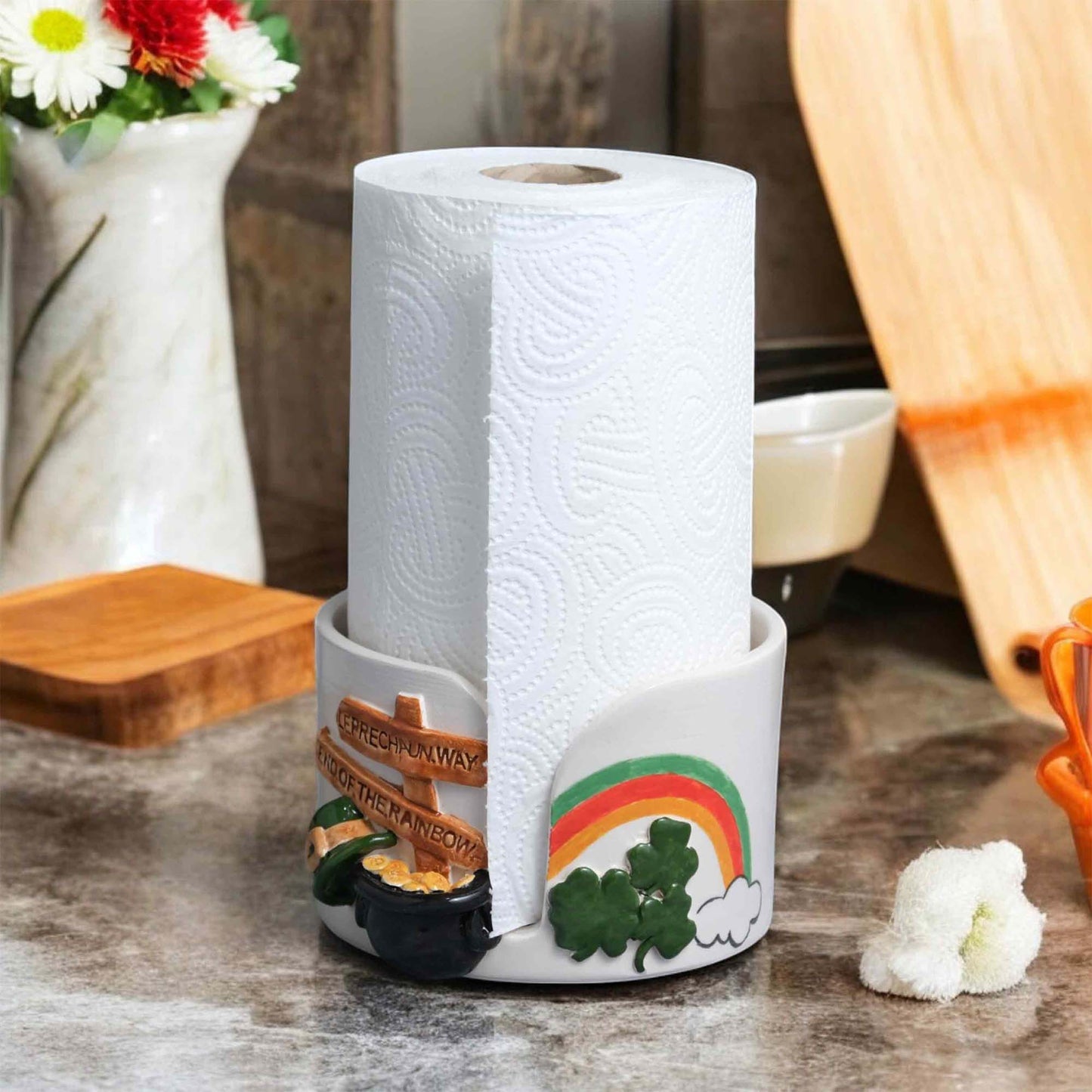 Decorative paper towel holder with paper towels on a kitchen counter.