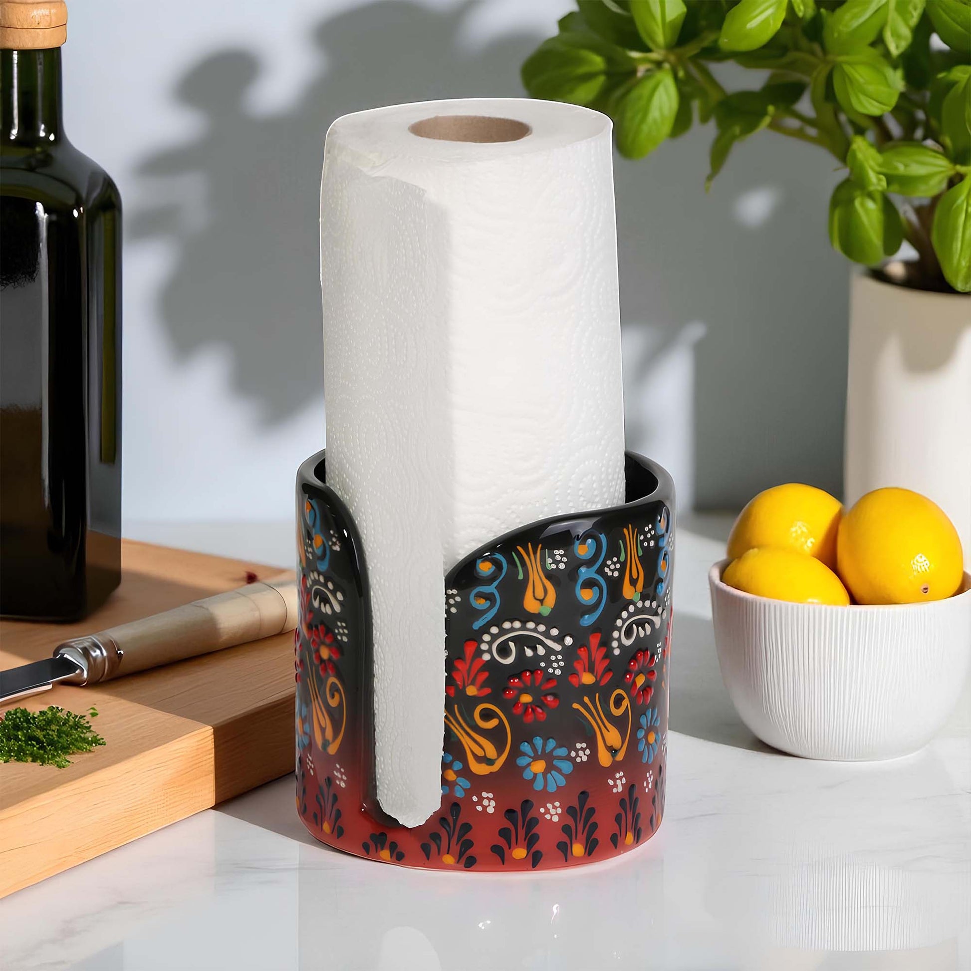 Decorative paper towel holder with a roll of paper towels on a kitchen counter.