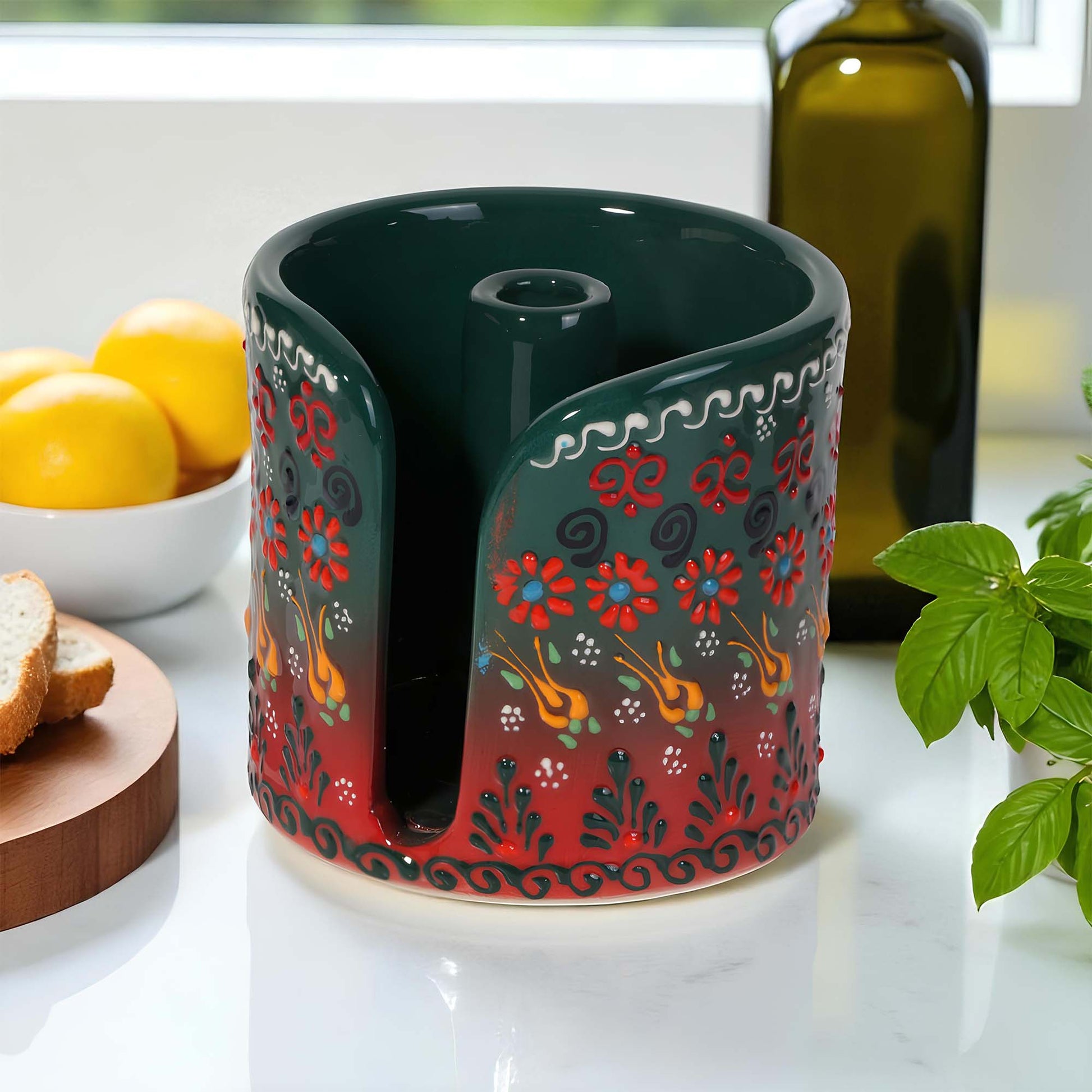 Decorative ceramic paper towel holder with floral patterns on a kitchen counter.