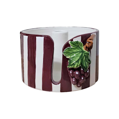 Ceramic paper towel holder with grape design on a white background