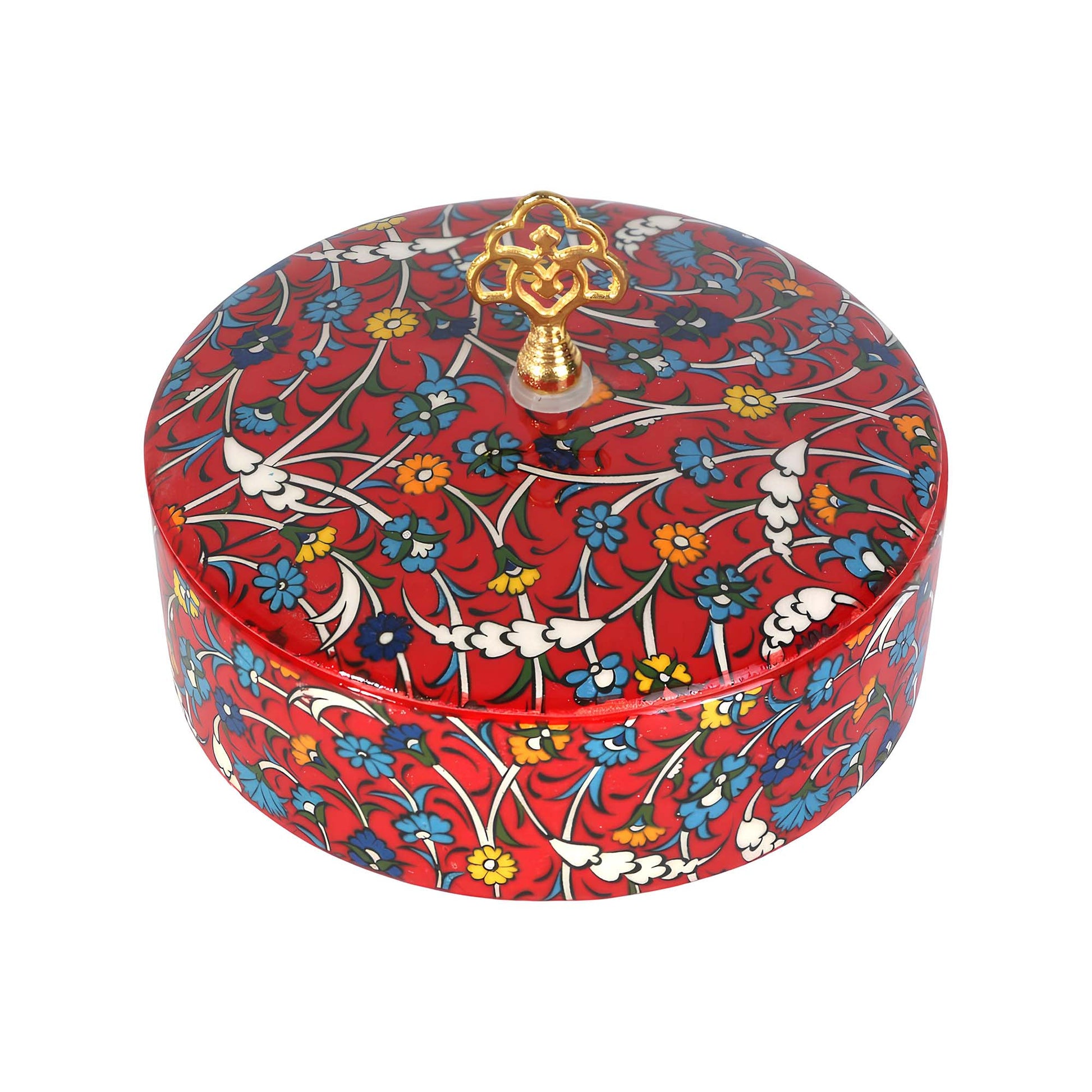 Decorative sugar bowl with floral pattern and gold lid finial on a white background