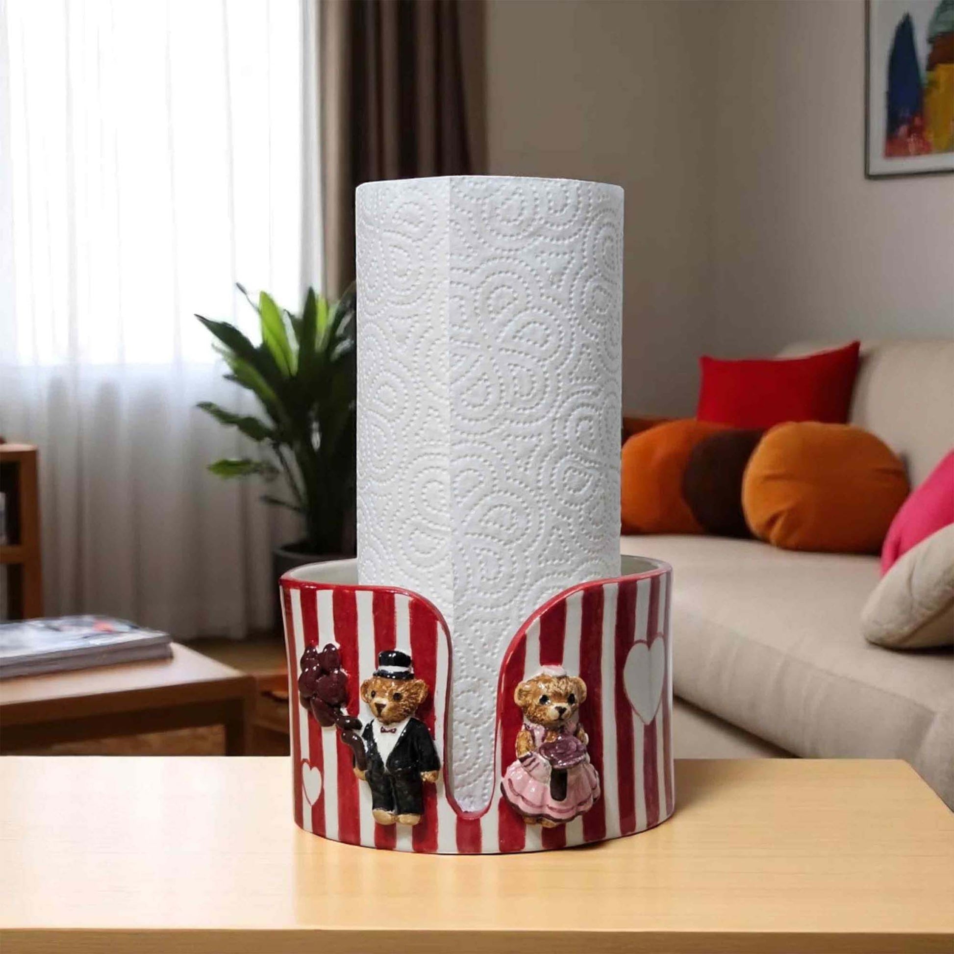 Paper towel roll with decorative paper towel holder featuring cartoon characters on a table in a living room.