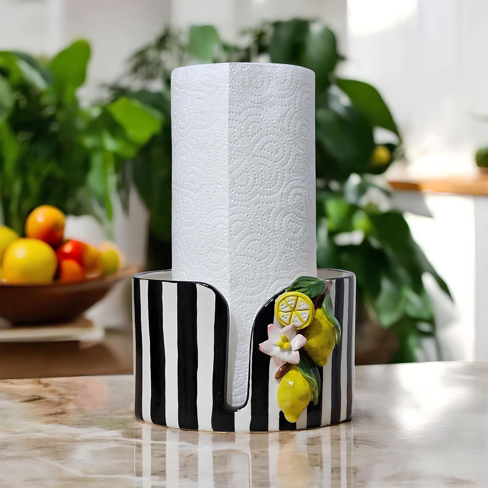 Decorative paper towel holder with black and white design on a kitchen counter.
