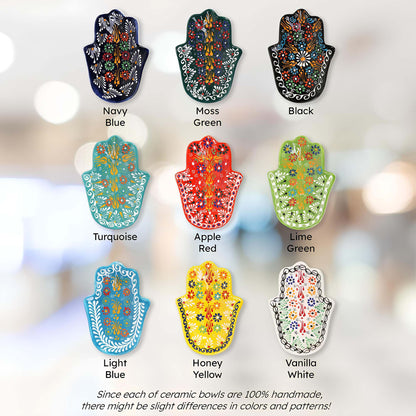 Colorful ceramic Hamsa hand jewelry trays in various colors with labels on a blurred background.