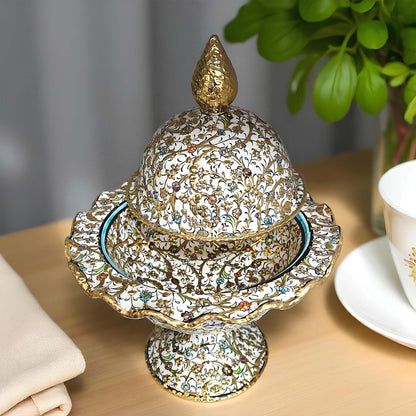 Decorative ceramic sugar bowl with intricate designs on a wooden surface.