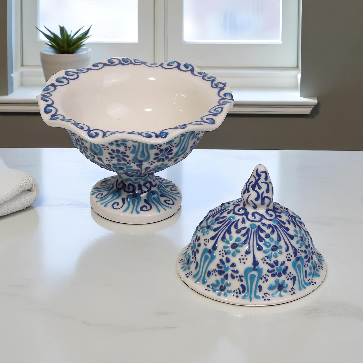 Ceramic sugar bowl with blue and white floral patterns on a light surface.