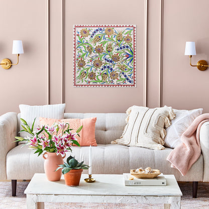 Decorative ceramic tile on wall above sofa with decorative pillows and plants.