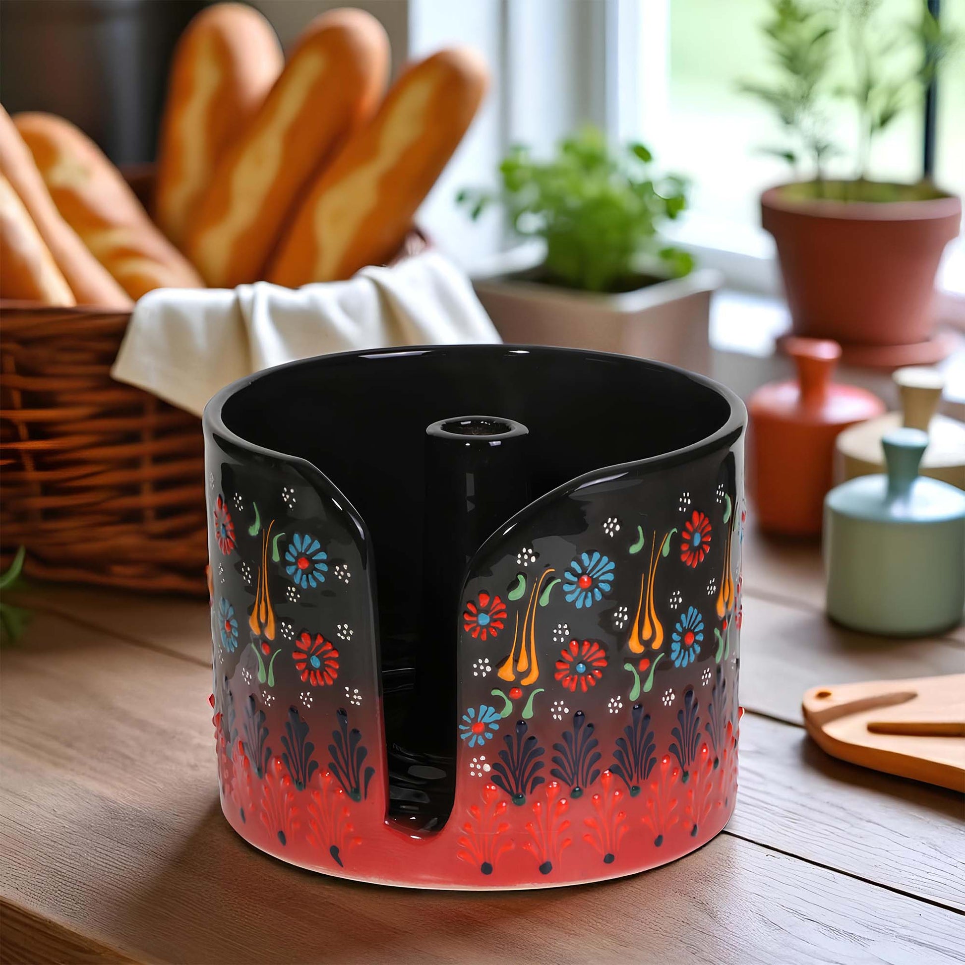 Decorative ceramic paper towel holder with floral patterns on a wooden surface