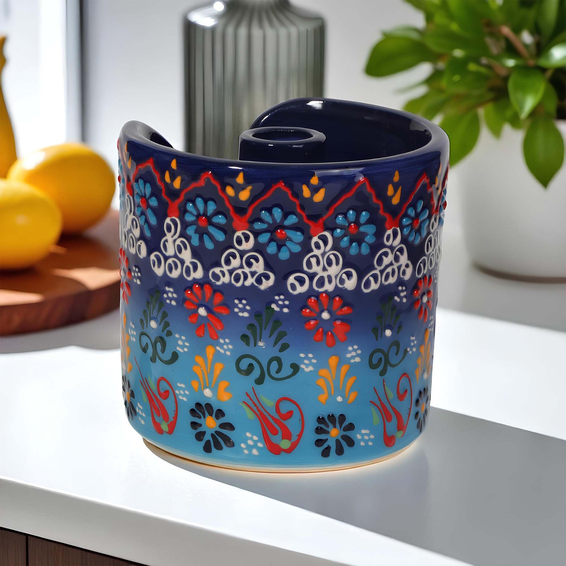 Decorative ceramic paper towel holder with colorful patterns on a surface.