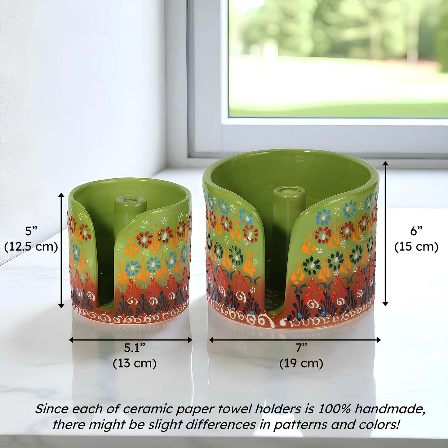 Two ceramic paper towel holders with floral patterns and measurements on a white surface.