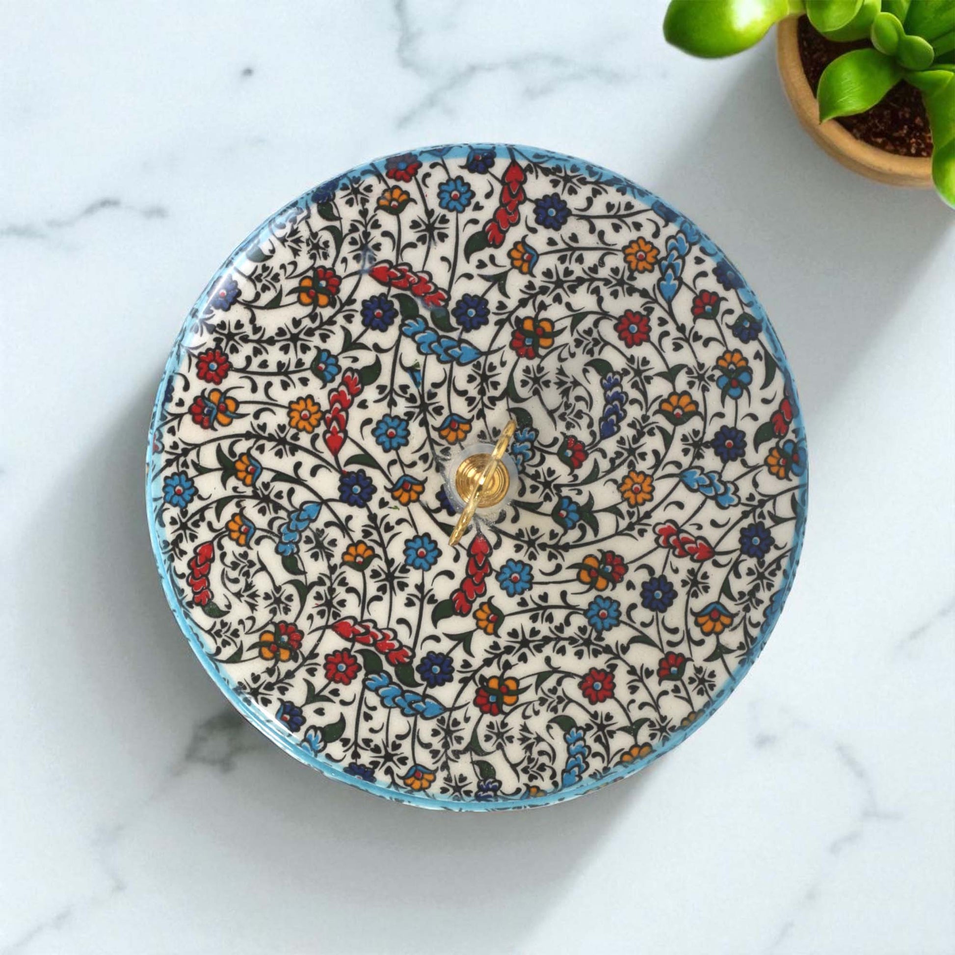 Decorative sugar bowl with floral pattern on a marble surface