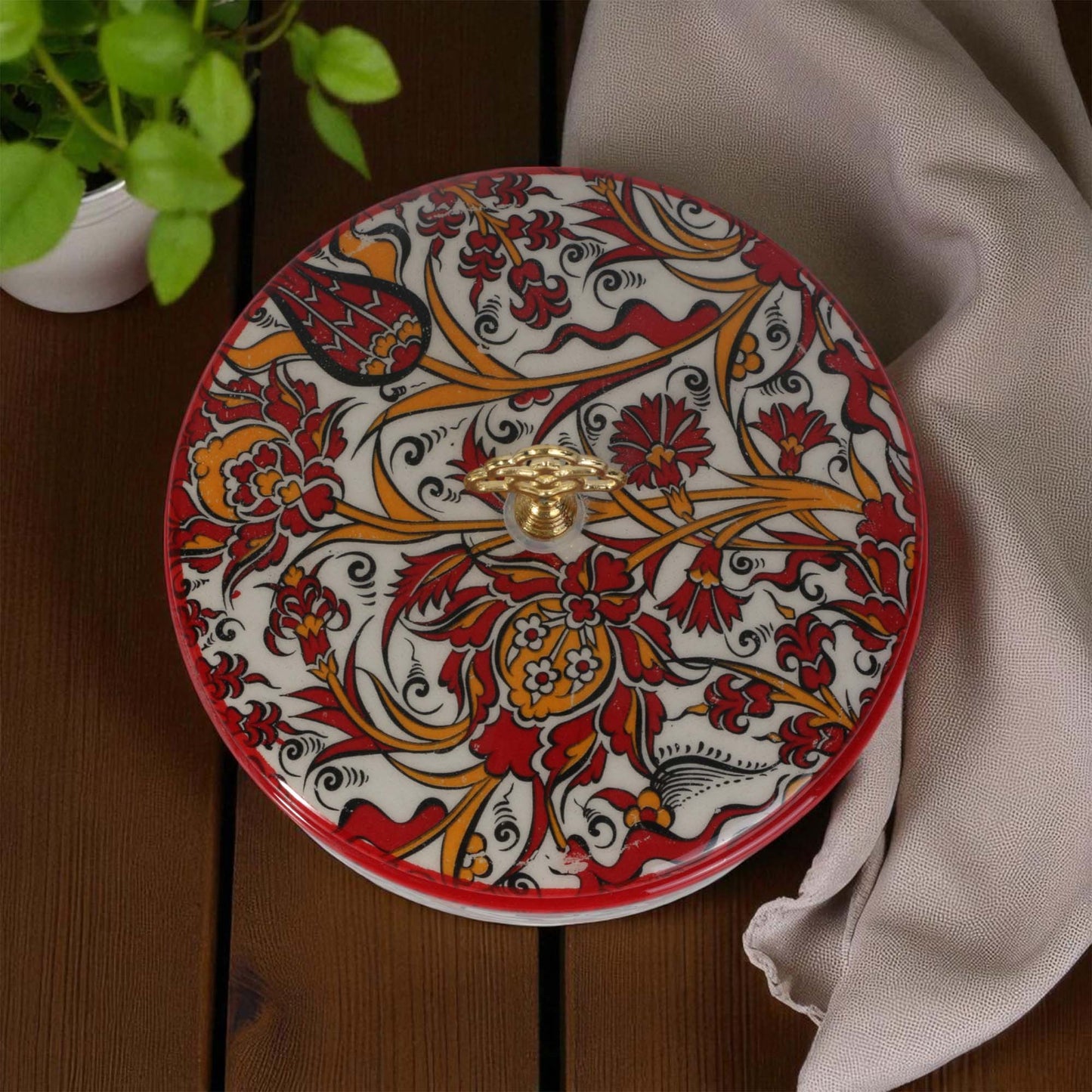 Decorative sugar bowl with intricate patterns on a wooden surface