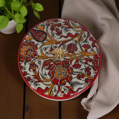 Decorative sugar bowl with intricate patterns on a wooden surface