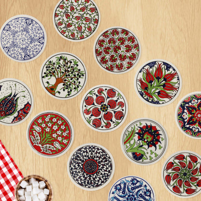 Decorative ceramic coasters with floral and geometric patterns on a wooden surface.