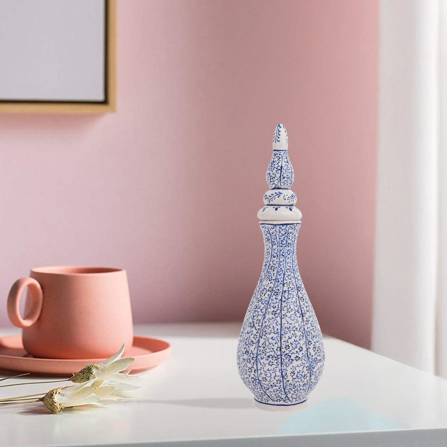 Hand-painted Iznik Nightingale’s Eye ceramic vase with lid, featuring blue vine motifs on white. Tall Ottoman-inspired design, perfect for décor or gifting.