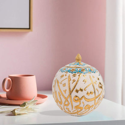 Hand-painted Gold Script globe jar with Arabic calligraphy in gold and turquoise floral trim. Spherical ceramic jar with gilded finial, perfect décor or gift.