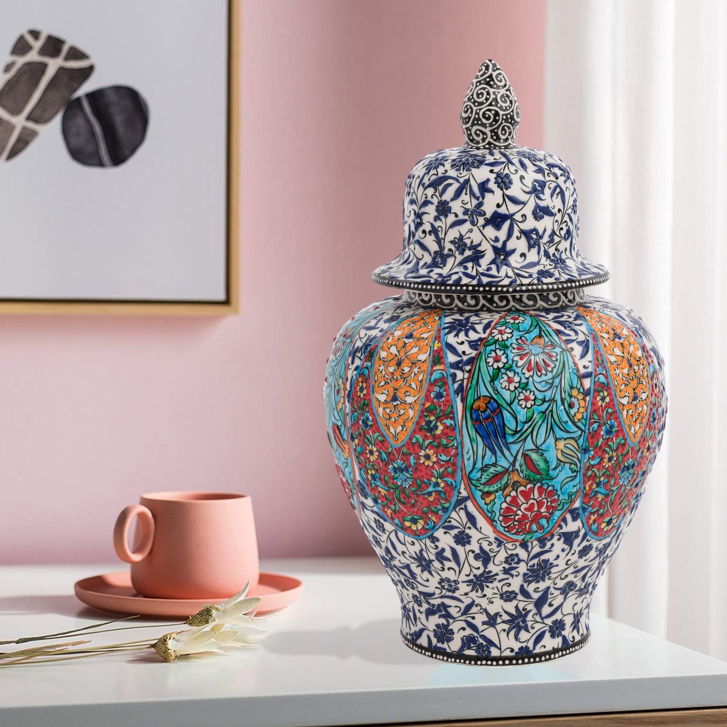 Hand-painted Garden Song ceramic jar with floral and bird motifs in vibrant panels. Lidded artisan jar with ornate finial, perfect décor accent or gift.