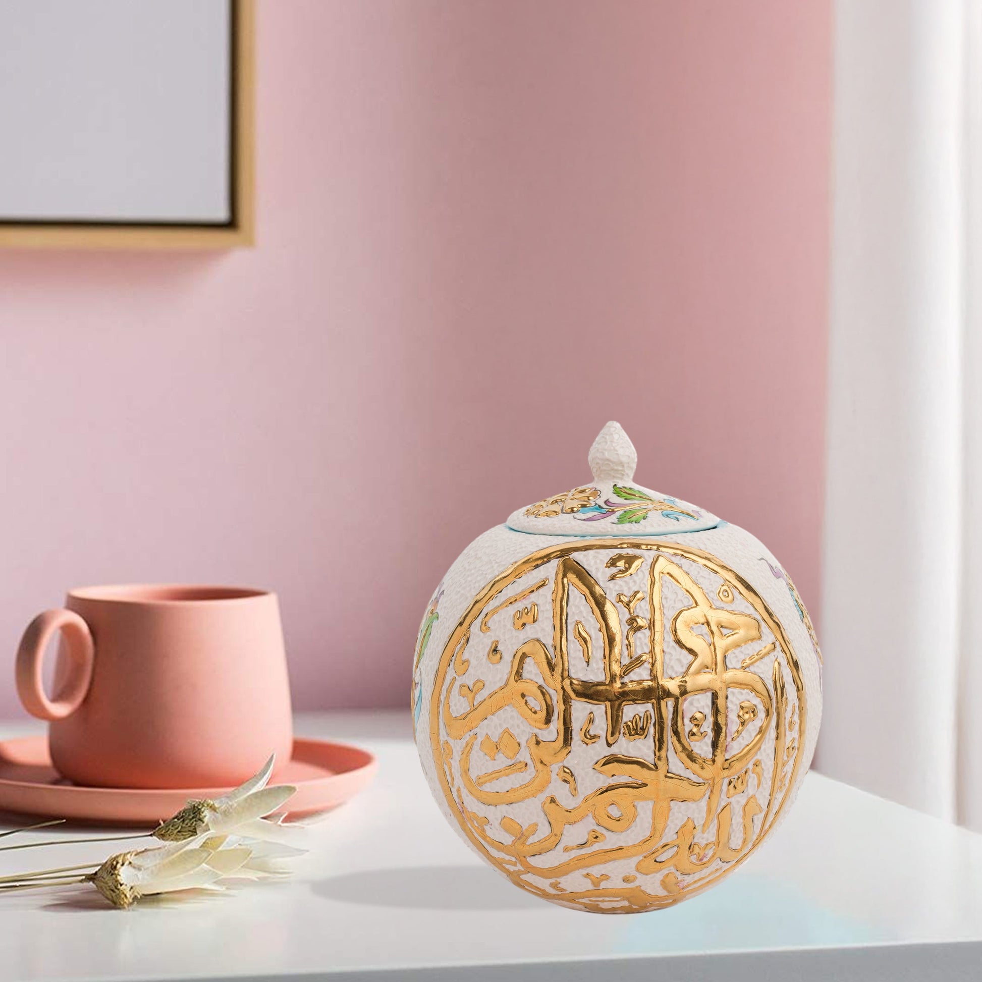 Hand-painted Gold Script globe jar with Arabic calligraphy and turquoise floral motifs. Spherical ceramic design with gold finial, perfect décor or gift.