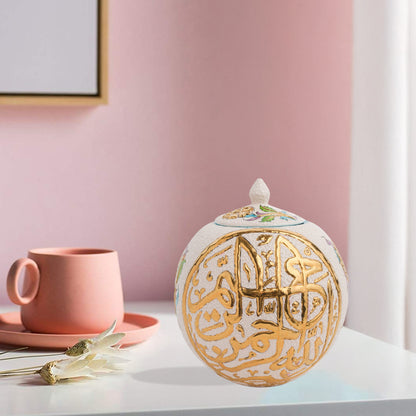 Hand-painted Gold Script globe jar with Arabic calligraphy and turquoise floral motifs. Spherical ceramic design with gold finial, perfect décor or gift.