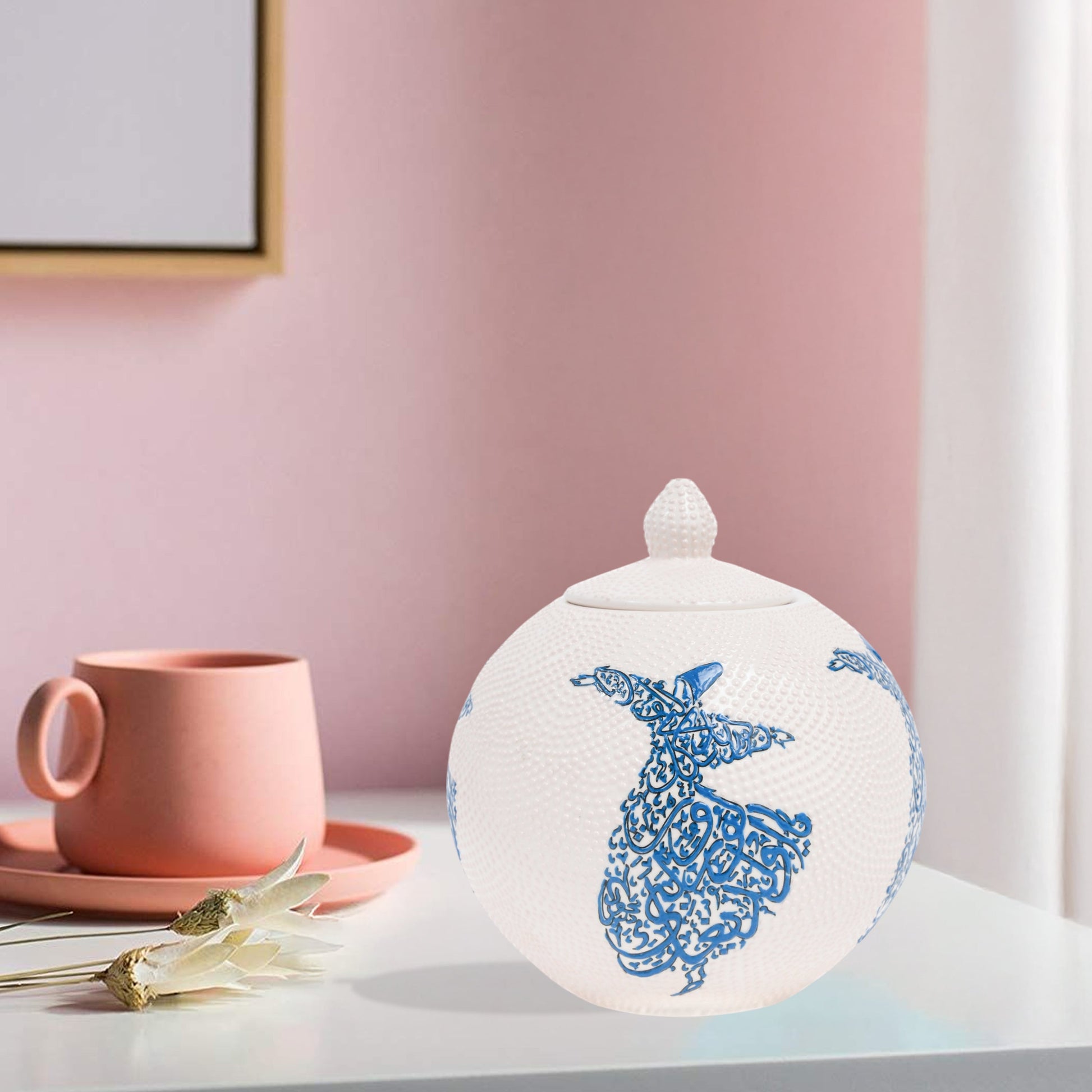 Hand-painted Whirling Dervish globe jar with Arabic calligraphy design. Available in blue or red, this ceramic round jar is perfect for spiritual décor or gifts.