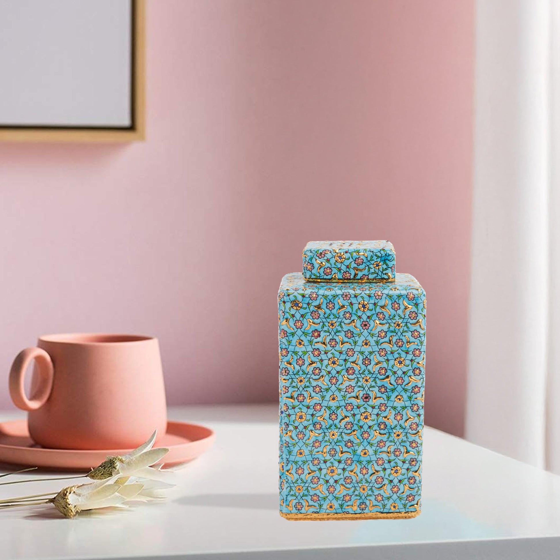 Hand-painted Golden Blossom ceramic jar with turquoise base and gold floral motifs. Square lidded design, artisan-made, perfect for décor, tea, or gifts.