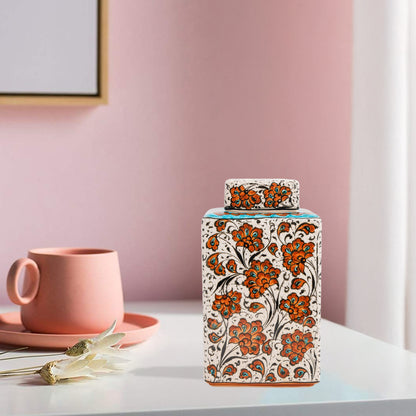 Hand-painted Terracotta Bloom ceramic jar with vivid orange floral motifs. Square lidded design, artisan-crafted, perfect for tea, spices, décor, or gifts.