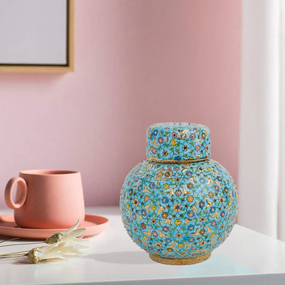Hand-painted Turquoise Blossom ceramic jar with lid. Features floral motifs in turquoise, lavender & gold. Round melon shape, artisan-made, perfect décor.