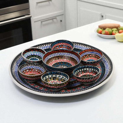 Decorative ceramic platter with colorful bowls on a kitchen counter